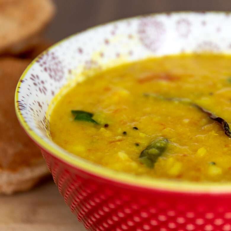 potato curry in red vibrant bowl