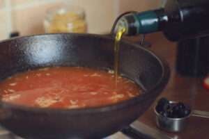 pouring olive oil to wok