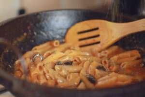 garnishing pasta with dried leaves