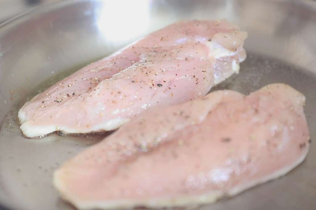 cooking seasoned chicken breast with salt and pepper olive oil