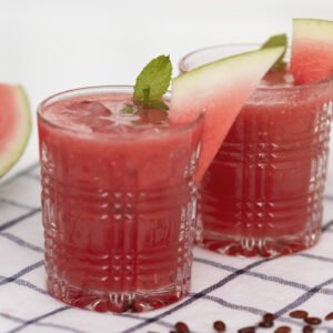 watermelon along with watermelon juice on two glasses