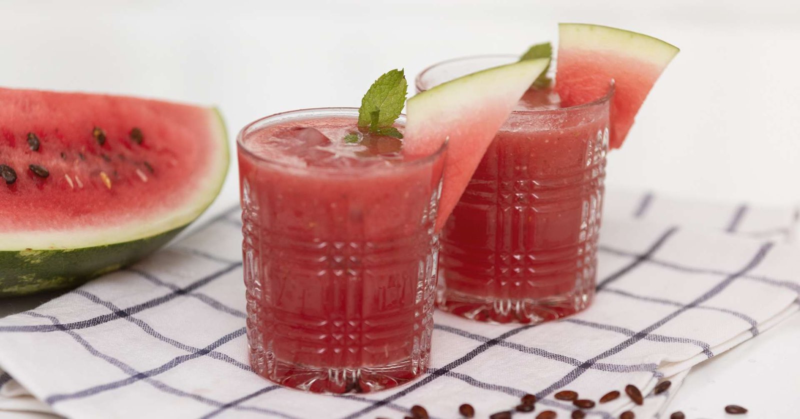 watermelon along with watermelon juice on two glasses