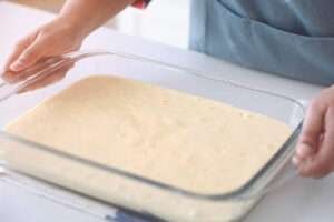 three milk cake batter on glass tray for baking
