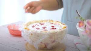 ice cream and strawberry sauce on swiss roll cake